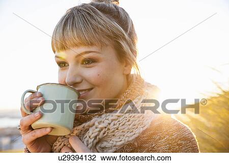 Portrait of young woman in sunlit marsh with drinks mug View Large Photo Image Stock Image - Portrait of young woman in sunlit marsh with drinks mug. Fotosearch