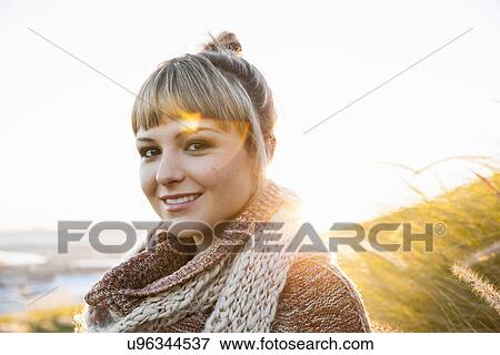 Stock Photo - Portrait of young woman in sunlit marsh. Fotosearch