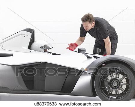 Racing driver and engineer in supercar in sports car factory View Large Photo Image Stock Image - Racing driver and engineer in supercar in sports car factory. Fotosearch