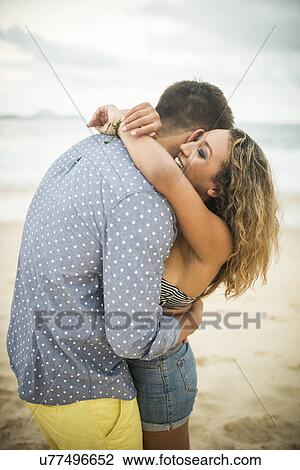 Stock Image - Romantic young couple hugging, Ipanema Beach, Rio de Janeiro, Brazil. Fotosearch