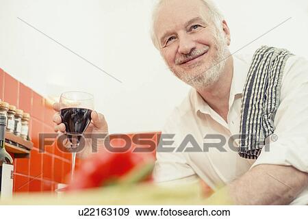 Senior man holding red wine, portrait View Large Photo Image Stock Photo - Senior man holding red wine, portrait. Fotosearch
