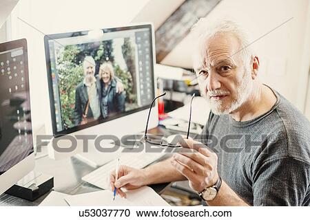 Stock Image - Senior man working at home. Fotosearch