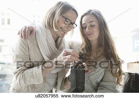 Senior woman and granddaughter admiring shopping in cafe View Large Photo Image Stock Photography - Senior woman and granddaughter admiring shopping in cafe. Fotosearch