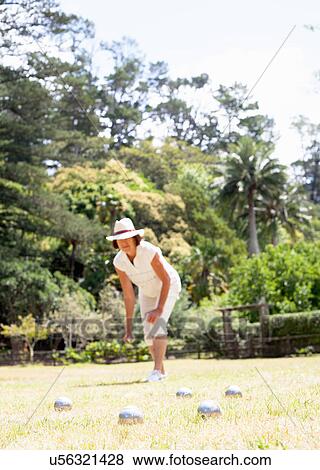 Senior woman playing boule in park View Large Photo Image Stock Photo - Senior woman playing boule in park. Fotosearch