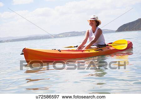 Senior woman sea kayaking View Large Photo Image Stock Photo - Senior woman sea kayaking. Fotosearch