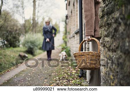 Senior woman standing in doorway, low angle view, waiting for mature woman, walking dog View Large Photo Image Stock Image - Senior woman standing in doorway, low angle view, waiting for mature woman, walking dog. Fotosearch