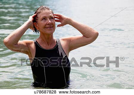 Senior woman swimmer with hands in wet hair View Large Photo Image Stock Photo - Senior woman swimmer with hands in wet hair. Fotosearch