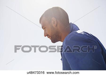 Stock Photograph - Side view of man in sweatshirt. Fotosearch