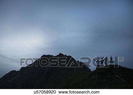 Silhouette of four young adult men with arms raised on top of mountain View Large Photo Image Stock Image - Silhouette of four young adult men with arms raised on top of mountain. Fotosearch