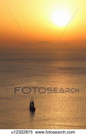 Silhouetted ship at sunset, Oia, Santorini, Cyclades Islands, Greece View Large Photo Image Stock Photography - Silhouetted ship at sunset, Oia, Santorini, Cyclades Islands, Greece. Fotosearch