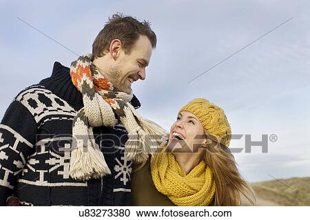 Smiling mid adult couple at coast View Large Photo Image Stock Image - Smiling mid adult couple at coast. Fotosearch