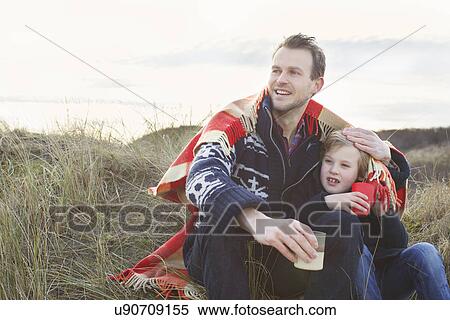 Smiling mid adult man and son on sand dunes View Large Photo Image Stock Photography - Smiling mid adult man and son on sand dunes. Fotosearch