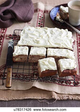 Still life of baking tray with sliced hummingbird cake View Large Photo Image Stock Photograph - Still life of baking tray with sliced hummingbird cake. Fotosearch