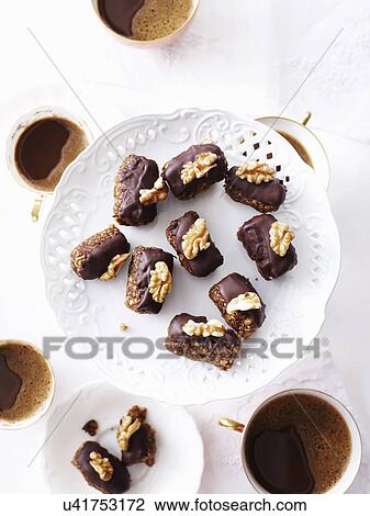 Stock Image - Still life of chocolate and walnut macadamia cakes. Fotosearch