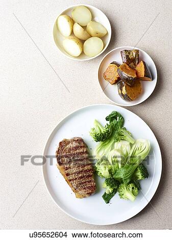 Still life of grilled steak with healthy vegetable sides View Large Photo Image Picture - Still life of grilled steak with healthy vegetable sides. Fotosearch