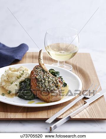 Stock Image - Still life of pork chop with rosemary crust and mashed potatoes. Fotosearch