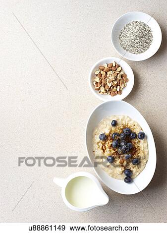 Stock Photo - Still life of porridge with fruit and nuts. Fotosearch