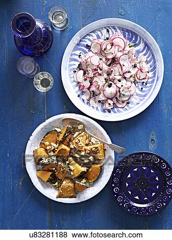 Stock Photo - Still life of roasted pumpkin with feta cheese and sliced radish. Fotosearch