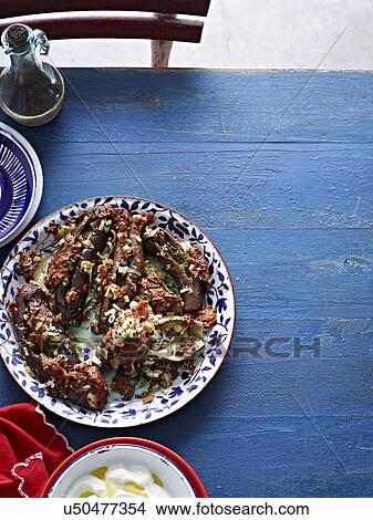 Picture - Still life of rustic style eggplant with yogurt dipping sauce. Fotosearch