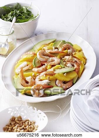 Stock Photograph - Still life of salad dish with prawns, avocado, mango and pine nuts. Fotosearch