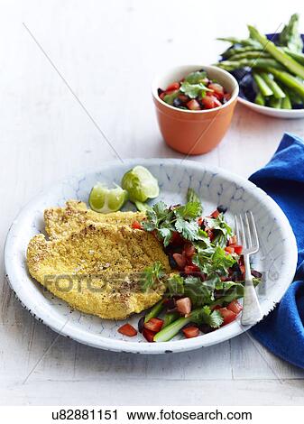 Stock Image - Still life of semolina chicken with asparagus, lime, coriander and beans. Fotosearch