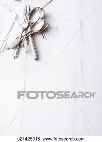 Still life of traditional cutlery on empty table View Large Photo Image Stock Photograph - Still life of traditional cutlery on empty table. Fotosearch