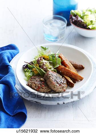 Still life of turkey patties with sweet potato and mesclun salad View Large Photo Image Stock Image - Still life of turkey patties with sweet potato and mesclun salad. Fotosearch