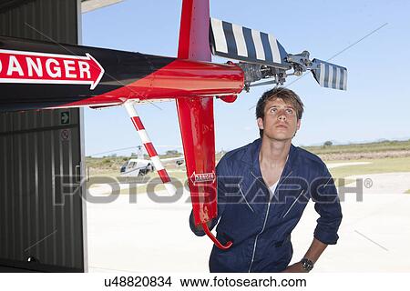 Student pilot checking tail rotor of helicopter View Large Photo Image Picture - Student pilot checking tail rotor of helicopter. Fotosearch