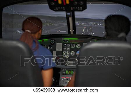 Stock Photo - Student pilots learning to fly helicopter. Fotosearch