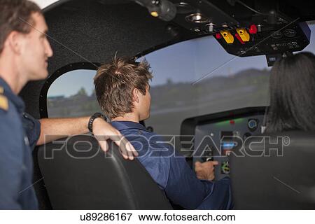 Stock Photo - Student pilots learning to fly helicopter. Fotosearch
