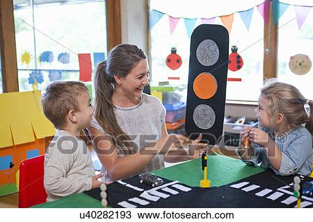 Teacher and pupils learning road crossing at nursery school View Large Photo Image Stock Image - Teacher and pupils learning road crossing at nursery school. Fotosearch