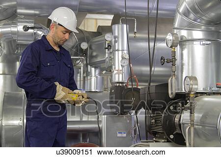 Technician monitoring pipe wiring in power station View Large Photo Image Stock Image - Technician monitoring pipe wiring in power station. Fotosearch