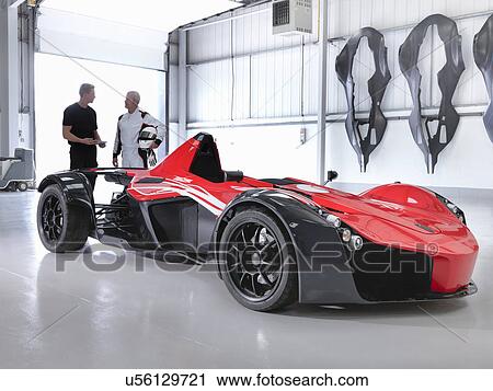 Test driver and engineer with supercar in car factory View Large Photo Image Stock Image - Test driver and engineer with supercar in car factory. Fotosearch