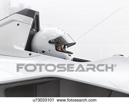 Test driver in crash helmet in supercar View Large Photo Image Stock Image - Test driver in crash helmet in supercar. Fotosearch
