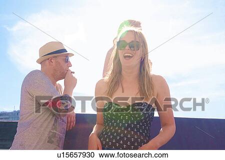 Three adult friends laughing on board yacht View Large Photo Image Stock Image - Three adult friends laughing on board yacht. Fotosearch