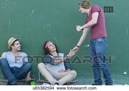 Three adult male friends meeting on street View Large Photo Image Picture - Three adult male friends meeting on street. Fotosearch