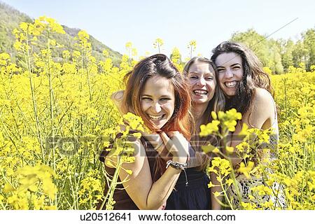 Three female friends in field, portrait View Large Photo Image Stock Image - Three female friends in field, portrait. Fotosearch