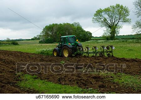 Tractor ploughing field View Large Photo Image Stock Image - Tractor ploughing field. Fotosearch