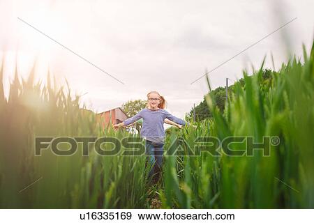 Two sisters running along field path View Large Photo Image Stock Photo - Two sisters running along field path. Fotosearch