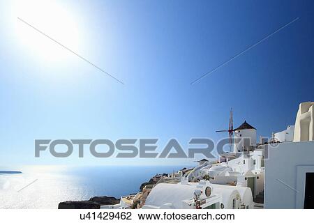Stock Image - View of Oia town and windmill, Santorini, Cyclades Islands, Greece. Fotosearch