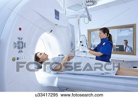 Stock Photography - Woman going into CT scanner. Fotosearch
