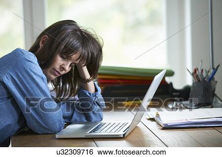 Woman sitting at desk with laptop, eyes closed View Large Photo Image Stock Photograph - Woman sitting at desk with laptop, eyes closed. Fotosearch