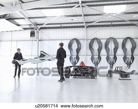 Picture - Workers preparing supercar in sports car factory. Fotosearch