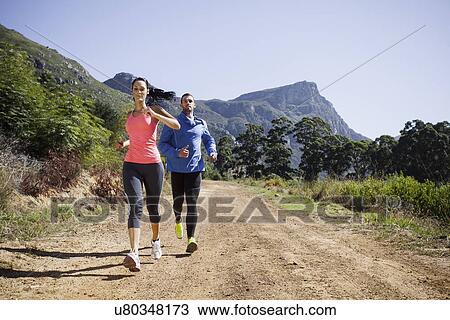 Young couple jogging in forest View Large Photo Image Stock Image - Young couple jogging in forest. Fotosearch