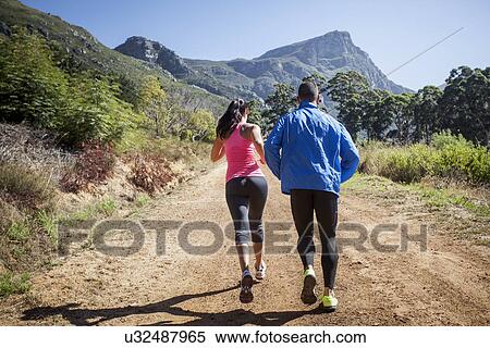 Young couple jogging in forest View Large Photo Image Stock Photography - Young couple jogging in forest. Fotosearch