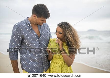 Young couple with coconut milk on Ipanema Beach, Rio de Janeiro, Brazil View Large Photo Image Stock Image - Young couple with coconut milk on Ipanema Beach, Rio de Janeiro, Brazil. Fotosearch