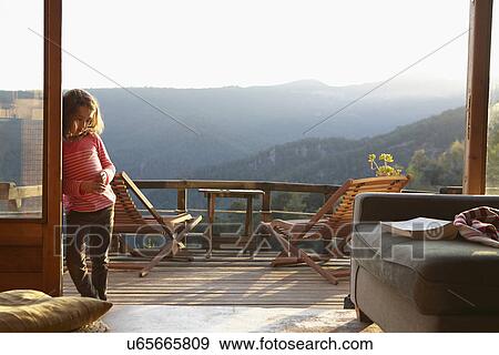 Young girl leaning against patio doors to balcony View Large Photo Image Stock Photo - Young girl leaning against patio doors to balcony. Fotosearch