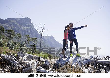 Young joggers enjoying view from hilltop View Large Photo Image Stock Photograph - Young joggers enjoying view from hilltop. Fotosearch