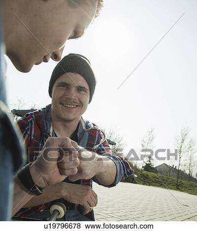 Young men doing fist bump View Large Photo Image Stock Photo - Young men doing fist bump. Fotosearch