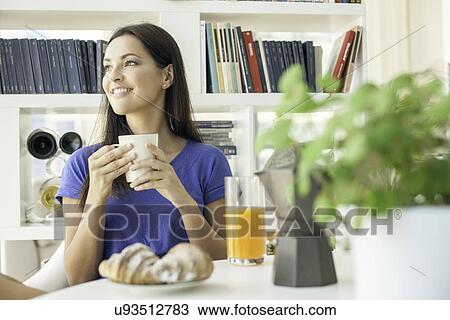 Young woman having breakfast View Large Photo Image Stock Image - Young woman having breakfast. Fotosearch